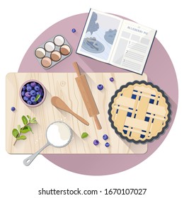 La mesa con ingredientes para cocinar pastel de arándano.