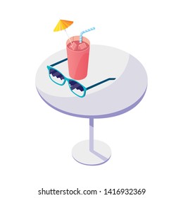 table with juice fruit cocktail and sunglasses