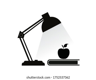 Table lamp, notebook and apple isolated on a white background.