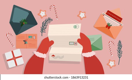 at the table with New Year's and Christmas letters Santa Claus reads letters with requests for a gift