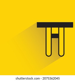 table  with shadown on yellow background