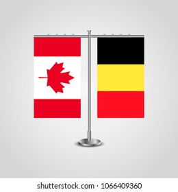 Table stand with flags of Canada and Belgium.Two flag. Flag pole. Symbolizing the cooperation between the two countries. Table flags
