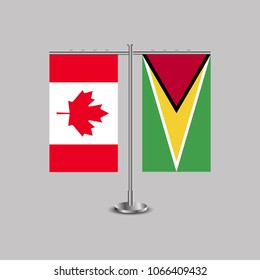 Table stand with flags of Canada and Guyana.Two flag. Flag pole. Symbolizing the cooperation between the two countries. Table flags