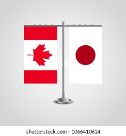 Table stand with flags of Canada and Japan.Two flag. Flag pole. Symbolizing the cooperation between the two countries. Table flags