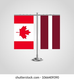 Table stand with flags of Canada and Latvia.Two flag. Flag pole. Symbolizing the cooperation between the two countries. Table flags