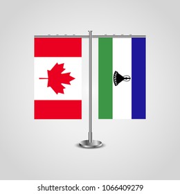 Table stand with flags of Canada and Lesotho.Two flag. Flag pole. Symbolizing the cooperation between the two countries. Table flags