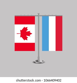 Table stand with flags of Canada and Luxembourg.Two flag. Flag pole. Symbolizing the cooperation between the two countries. Table flags