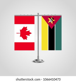 Table stand with flags of Canada and Mozambique.Two flag. Flag pole. Symbolizing the cooperation between the two countries. Table flags