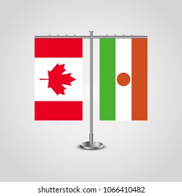 Table stand with flags of Canada and Niger.Two flag. Flag pole. Symbolizing the cooperation between the two countries. Table flags