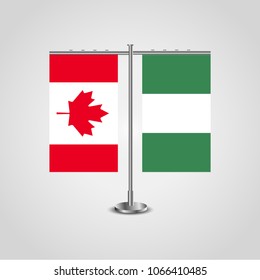 Table stand with flags of Canada and Nigeria.Two flag. Flag pole. Symbolizing the cooperation between the two countries. Table flags