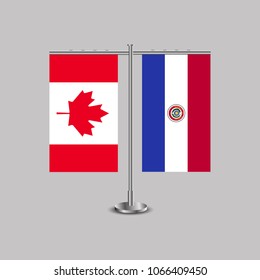 Table stand with flags of Canada and Paraguay.Two flag. Flag pole. Symbolizing the cooperation between the two countries. Table flags