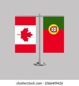 Table stand with flags of Canada and Portugal.Two flag. Flag pole. Symbolizing the cooperation between the two countries. Table flags