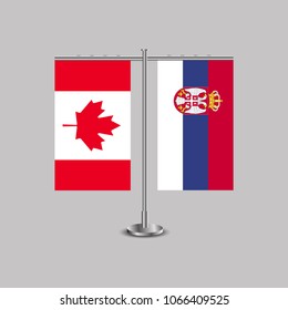Table stand with flags of Canada and Serbia.Two flag. Flag pole. Symbolizing the cooperation between the two countries. Table flags