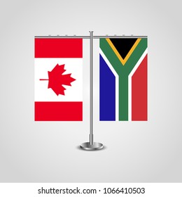 Table stand with flags of Canada and South Africa.Two flag. Flag pole. Symbolizing the cooperation between the two countries. Table flags