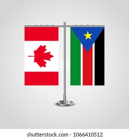 Table stand with flags of Canada and Southern Sudan.Two flag. Flag pole. Symbolizing the cooperation between the two countries. Table flags