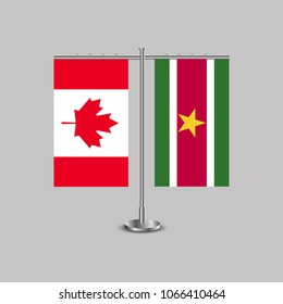 Table stand with flags of Canada and Suriname.Two flag. Flag pole. Symbolizing the cooperation between the two countries. Table flags