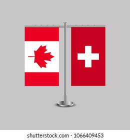 Table stand with flags of Canada and Switzerland.Two flag. Flag pole. Symbolizing the cooperation between the two countries. Table flags