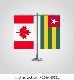 Table stand with flags of Canada and Togo.Two flag. Flag pole. Symbolizing the cooperation between the two countries. Table flags