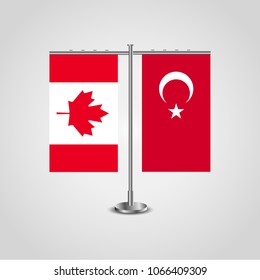 Table stand with flags of Canada and Turkey.Two flag. Flag pole. Symbolizing the cooperation between the two countries. Table flags