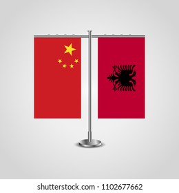 Table stand with flags of China and Albania.Two flag. Flag pole. Symbolizing the cooperation between the two countries. Table flags