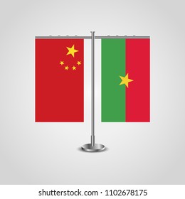 Table stand with flags of China and Burkina Faso.Two flag. Flag pole. Symbolizing the cooperation between the two countries. Table flags