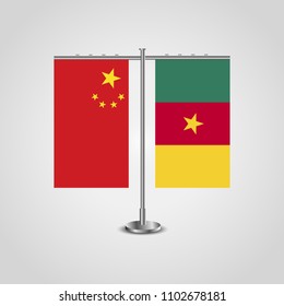 Table stand with flags of China and Cameroon.Two flag. Flag pole. Symbolizing the cooperation between the two countries. Table flags