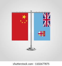 Table stand with flags of China and Fiji.Two flag. Flag pole. Symbolizing the cooperation between the two countries. Table flags