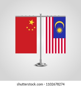 Table stand with flags of China and Malaysia.Two flag. Flag pole. Symbolizing the cooperation between the two countries. Table flags