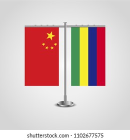 Table stand with flags of China and Mauritius.Two flag. Flag pole. Symbolizing the cooperation between the two countries. Table flags