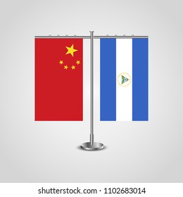 Table stand with flags of China and Nicaragua.Two flag. Flag pole. Symbolizing the cooperation between the two countries. Table flags