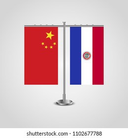 Table stand with flags of China and Paraguay.Two flag. Flag pole. Symbolizing the cooperation between the two countries. Table flags