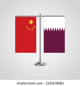 Table stand with flags of China and Qatar.Two flag. Flag pole. Symbolizing the cooperation between the two countries. Table flags