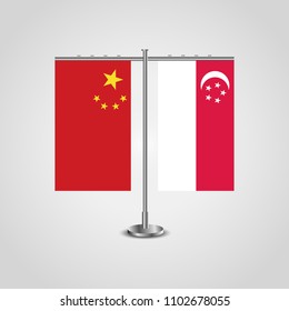 Table stand with flags of China and Singapore.Two flag. Flag pole. Symbolizing the cooperation between the two countries. Table flags