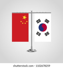 Table stand with flags of China and South Korea.Two flag. Flag pole. Symbolizing the cooperation between the two countries. Table flags