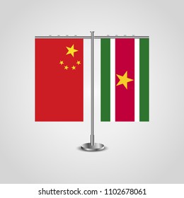 Table stand with flags of China and Suriname.Two flag. Flag pole. Symbolizing the cooperation between the two countries. Table flags