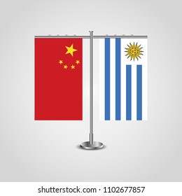 Table stand with flags of China and Uruguay.Two flag. Flag pole. Symbolizing the cooperation between the two countries. Table flags