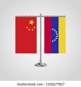 Table stand with flags of China and Venezuela.Two flag. Flag pole. Symbolizing the cooperation between the two countries. Table flags