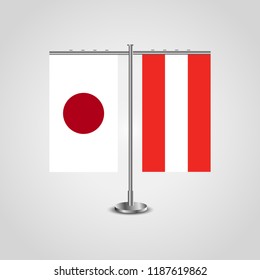 Table stand with flags of Japan and Austria.Two flag. Flag pole. Symbolizing the cooperation between the two countries. Table flags