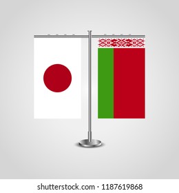Table stand with flags of Japan and Belarus.Two flag. Flag pole. Symbolizing the cooperation between the two countries. Table flags