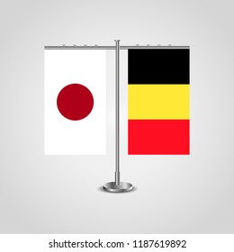 Table stand with flags of Japan and Belgium.Two flag. Flag pole. Symbolizing the cooperation between the two countries. Table flags
