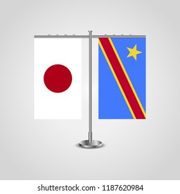 Table stand with flags of Japan and Democratic Republic of the Congo.Two flag. Flag pole. Symbolizing the cooperation between the two countries. Table flags