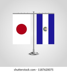 Table stand with flags of Japan and El Salvador.Two flag. Flag pole. Symbolizing the cooperation between the two countries. Table flags