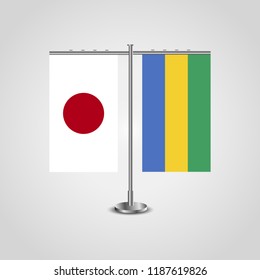 Table stand with flags of Japan and Gabon.Two flag. Flag pole. Symbolizing the cooperation between the two countries. Table flags