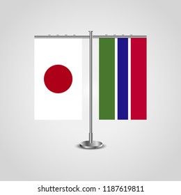 Table stand with flags of Japan and Gambia.Two flag. Flag pole. Symbolizing the cooperation between the two countries. Table flags