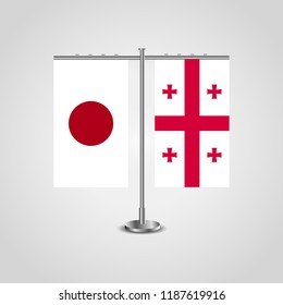 Table stand with flags of Japan and Georgia.Two flag. Flag pole. Symbolizing the cooperation between the two countries. Table flags