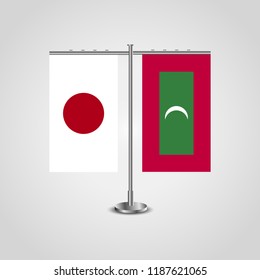 Table stand with flags of Japan and Maldives.Two flag. Flag pole. Symbolizing the cooperation between the two countries. Table flags