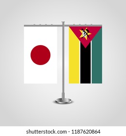 Table stand with flags of Japan and Mozambique.Two flag. Flag pole. Symbolizing the cooperation between the two countries. Table flags