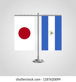 Table stand with flags of Japan and Nicaragua.Two flag. Flag pole. Symbolizing the cooperation between the two countries. Table flags