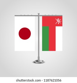 Table stand with flags of Japan and Oman.Two flag. Flag pole. Symbolizing the cooperation between the two countries. Table flags