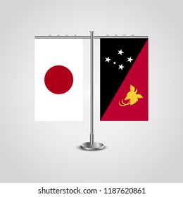 Table stand with flags of Japan and Papua New Guinea.Two flag. Flag pole. Symbolizing the cooperation between the two countries. Table flags
